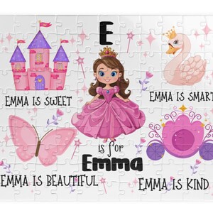 May include: A jigsaw puzzle with a princess theme. The puzzle features a pink castle, a swan with a crown, a butterfly, and a carriage. Text on the puzzle reads "Emma is Sweet", "Emma is Smart", "Emma is Beautiful", and "Emma is Kind".