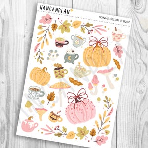 May include: A sticker sheet labeled HANCANPLAN BONUS DECOR B222 featuring autumn-themed illustrations including orange and pink pumpkins with bows, various mugs with hot beverages, colorful fall leaves, mushrooms, and small sprigs of foliage.