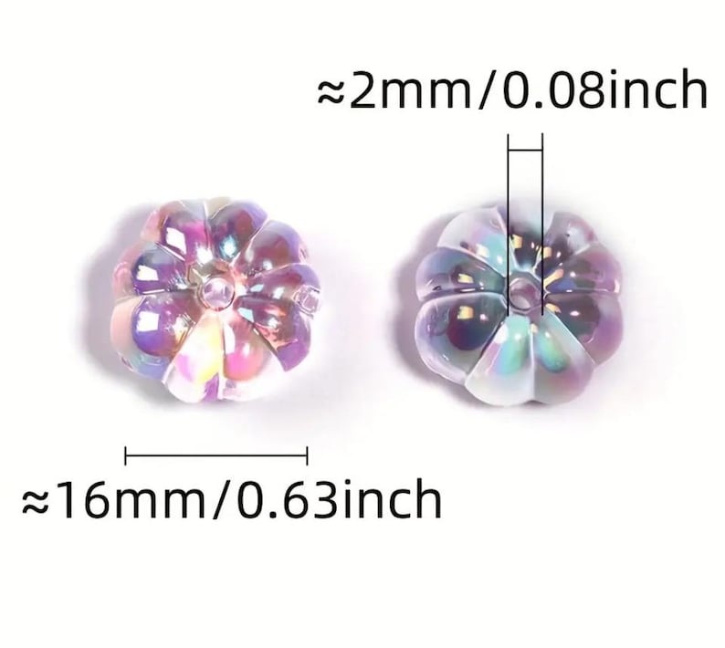 May include: Two iridescent purple pumpkin-shaped beads with a hole in the center. The beads are approximately 0.63 inches wide and 0.08 inches thick.
