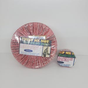 May include: Two red and white striped ceramic pots with the text "Thief Me Not" and "Thief Me Not" on them. The text is in yellow and black. The pots are for burying in the ground to protect your home from theft.