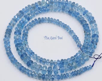 May include: A strand of faceted, light blue gemstone beads arranged in a circular pattern. The beads are translucent and vary slightly in size and shape. The text The Gem Bee is printed in the center of the circular bead arrangement.