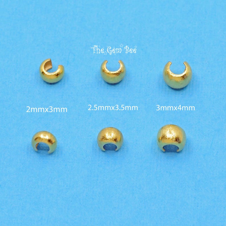 May include: Six gold-coloured metal jump rings in different sizes. The jump rings are arranged in two rows of three. The jump rings are labelled with their measurements in millimetres. The text "The Gem Bee" is at the top of the image.
