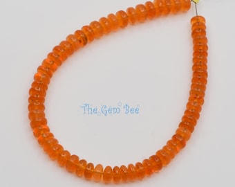 May include: A strand of translucent orange rondelle-shaped beads arranged in a U-shape on a thin wire. The beads have a smooth, polished finish and a consistent vibrant color. The text The Gem Bee is printed in blue in the center of the image.