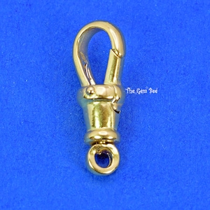 May include: Gold-toned metal clasp with a spring-loaded hook and a round ring. The clasp is designed for attaching to a chain or other jewelry.