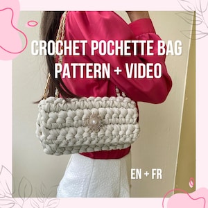 May include: A white crocheted handbag with a gold chain strap and a jeweled embellishment. The bag is being held by a person wearing a red shirt and white skirt. The text "CROCHET POCHETTE BAG PATTERN + VIDEO EN + FR" is displayed on the image.