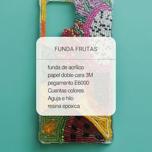 May include: A clear phone case with a colorful beaded fruit design. The case has a white label with the text "FUNDA FRUTAS" and a list of materials in Spanish. The background is a solid teal color.
