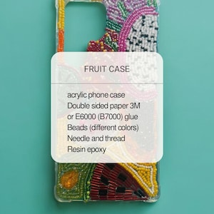 May include: A clear acrylic phone case with a beaded fruit design. The case features a variety of colourful beads in a fruit pattern, with the text "FRUIT CASE" on a white label. The background is a solid teal colour.