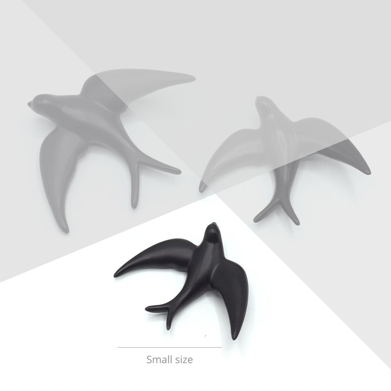 May include: Three black ceramic swallow bird wall decor pieces. The two larger swallows are in flight, while the smaller swallow is perched with its wings spread. The smaller swallow is labeled "Small size".
