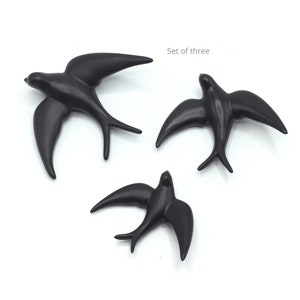 May include: Set of three black ceramic swallow bird wall decor.