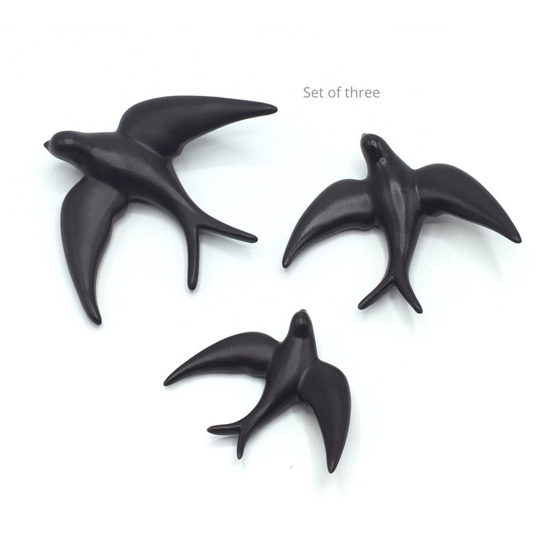 May include: Set of three black ceramic swallow bird wall decor.
