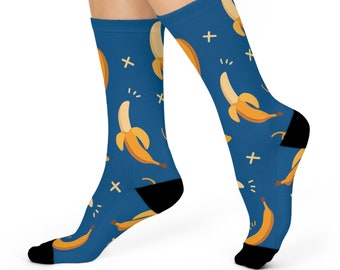 May include: A pair of blue socks with a pattern of yellow bananas. The socks have a black heel and toe.