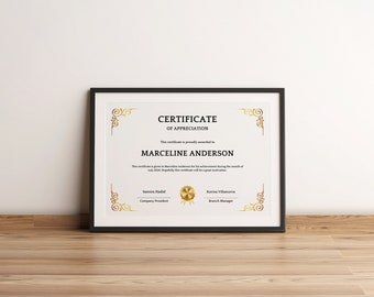 May include: A framed certificate of appreciation awarded to Marceline Anderson for her achievements during the month of July. The certificate is decorated with gold ornate borders and features the names of the company president and branch manager.