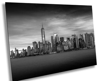 May include: A black and white photograph of the New York City skyline, featuring the iconic skyscrapers of Manhattan, including the Freedom Tower.