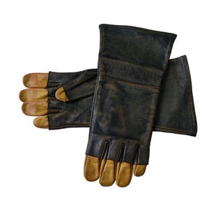 May include: A pair of black leather gloves with brown leather fingertips. The gloves have a long cuff and are designed for protection.