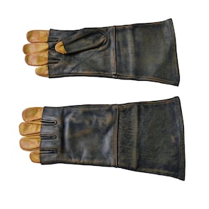 May include: A pair of brown leather gloves with tan leather fingertips. The gloves are worn and have a distressed look.