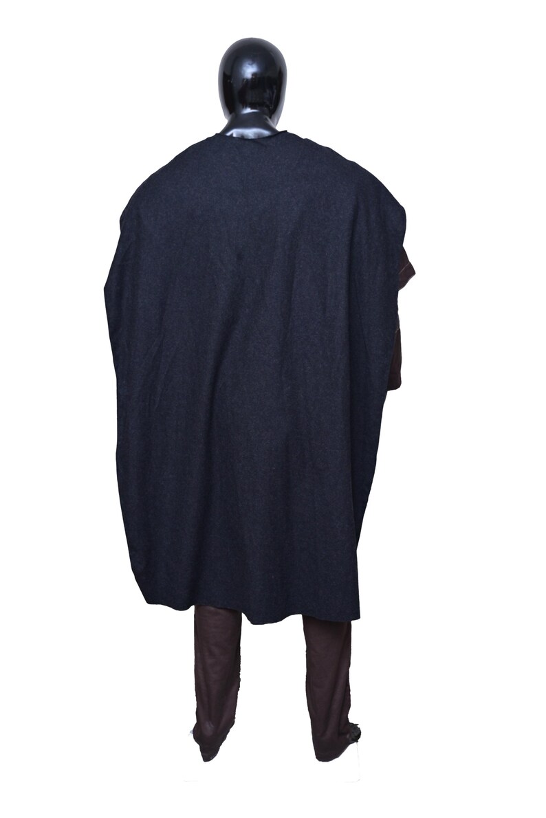 May include: A dark blue hooded cloak with a long, flowing design. The cloak is worn over brown pants.
