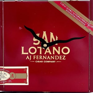 May include: A red wooden cigar box with a gold label that reads "Tabacalera AJ Fernandez Cigars Hecho en Republica de Nicaragua". The box also features a gold logo that reads "San Lotano AJ Fernandez Cigar Company".