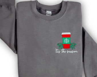 May include: Gray sweatshirt with a red and green embroidered coffee cup and the text "'tis the season".
