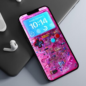 May include: A pink and blue smartphone with a Game Boy-inspired design. The screen displays the time, "Tuesday, September 6, 10:14 AM".