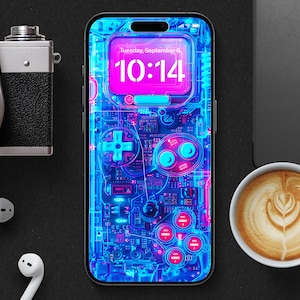 Puede incluir: Un teléfono inteligente azul y rosa con un diseño de mando de juego retro. La pantalla muestra un reloj digital que muestra la hora 10:14 y el día "Martes, 5 de septiembre".