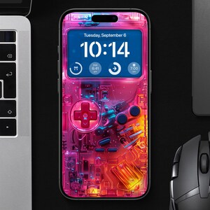 Puede incluir: Un teléfono inteligente rosa y azul con un diseño personalizado de mando de juego. La pantalla muestra la hora, "Martes, 6 de septiembre, 10:14".