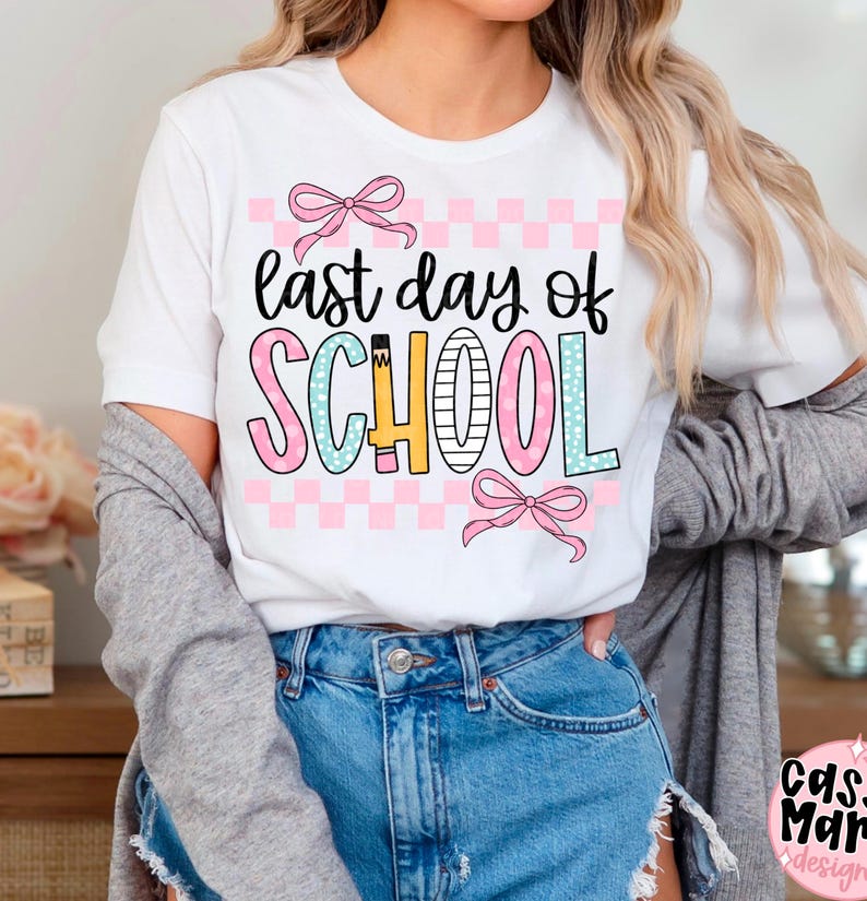 May include: White t-shirt with the text "last day of SCHOOL" in black, pink, blue, and yellow. The word "SCHOOL" is in a colorful, playful font with a pink and white checkered background and pink bows.