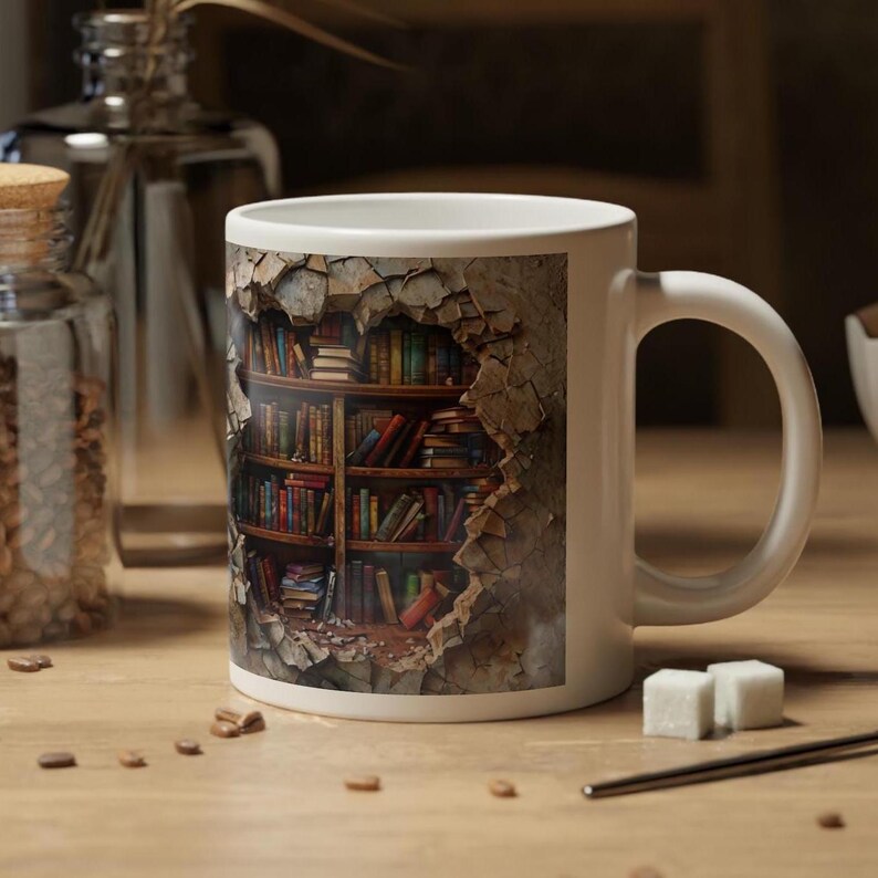 May include: White ceramic mug with a printed image of a bookshelf filled with books inside a broken wall. The bookshelf is made of wood and the books are various colors and sizes.