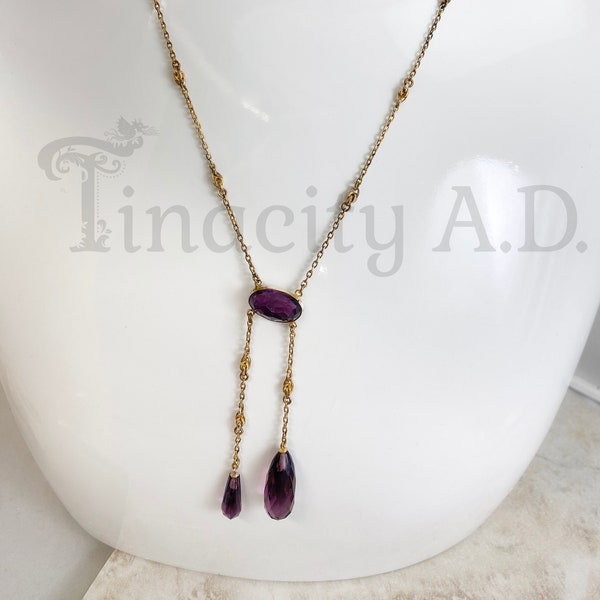 A Lovely and Whimsical Art Nouveau Lavalier Featuring Deep Amethyst Purple Cut Glass and Delicate Decorative Knot Links, Circa 1900