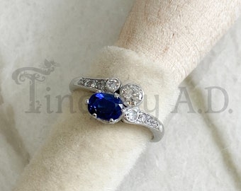 A Gorgeous Vintage Art Deco Platinum Ring Featuring an Antique Cushion-Cut Blue Sapphire and Round Accent Diamonds, Circa 1930's.