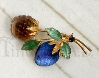 Vintage Austrian Iridescent Lucite Fruit Pin with Green Leaves and Purple Rhinestone Accent in Gold Tone Mounting, Circa 1950's.