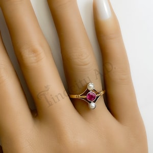 An Antique Edwardian-Style 18k Yellow Gold Split Shank Ring with Imitation Ruby Center and Seed Pearl Accents, Circa 1920