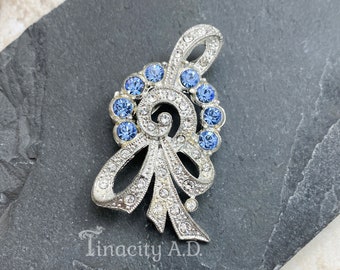 Vintage Art Deco Pin-Brooch Featuring Sapphire Blue and Clear Rhinestones in Flowery-Ribbon Style Setting.