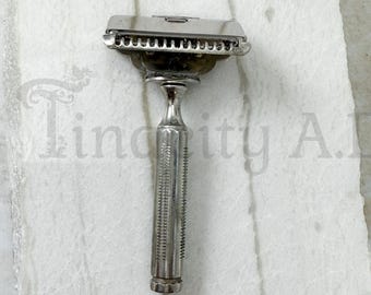 A Vintage Silver-Tone Gem Safety Razor with Massage Bar and Textured Handle, Patented 1912.