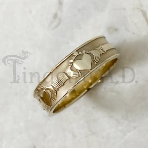 A Vintage 14k Yellow Gold Band with a Raised Claddagh Design Continuously Around, Size 7 3/4, Circa 1990&#39;s.