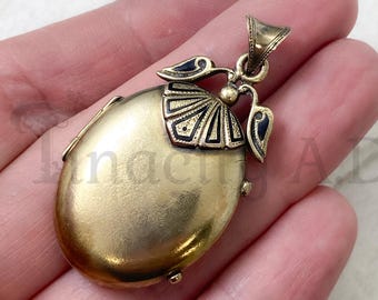 An Antique 14k Yellow Gold Victorian Locket with Black Enameled Geometric Design, Hinged Bail and Tinted Photographs, Circa 1870's.