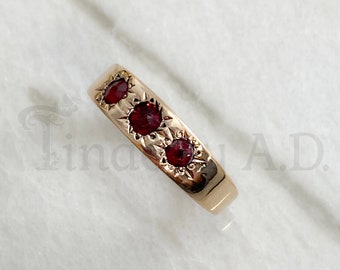 A Vintage Classic, 14k Yellow Gold Tapered Band set with Imitation Rubies in Star Shaped Settings, Circa 1930's.