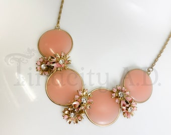 A Vintage 1960's Era Choker Necklace with Pastel Pink Plastic Disc and Enameled Flowery Accents