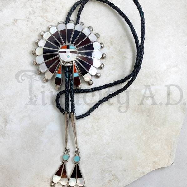 A Vintage Large Sterling Silver Zuni Sun God Bolo Tie with Inlaid Stones and Original Braided Leather Cord, Circa 1960's