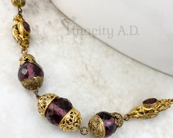 Vintage Czech Strand of Purple Cut Glass Beads with Gold-Tone Filigree Accent Elements, 36-Inches with Spring Ring Clasp, Circa 1920's.