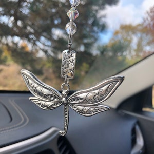 May include: Silver dragonfly car charm with a crystal beaded chain and a tag that reads "find joy in the journey".
