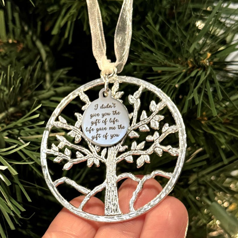 May include: Silver tree of life ornament with a round tag that reads "I didn't give you the gift of life. Life gave me the gift of you."