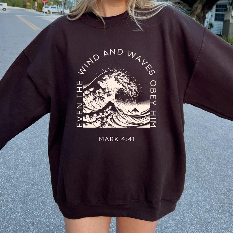 May include: Black sweatshirt with a white graphic of a wave and the text "Even the wind and waves obey him Mark 4:41"