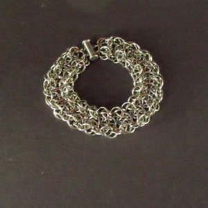 May include: A silver chainmail bracelet with a silver clasp.