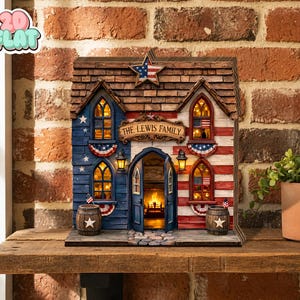 May include: A decorative wooden house model featuring a patriotic American flag theme with red, white, and blue colors. The structure includes a central arched doorway, illuminated windows, a star accent, and a sign reading THE LEWIS FAMILY.