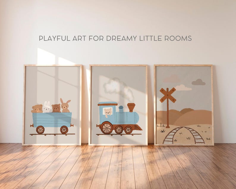 May include: Three framed prints with a whimsical train theme. The first print features a blue train with a brown bear, a white rabbit, and a brown bunny riding in the car. The second print shows a blue train with white smoke coming from the chimney. The third print shows a brown wooden railroad crossing sign with a brown wooden fence and a brown dirt path.
