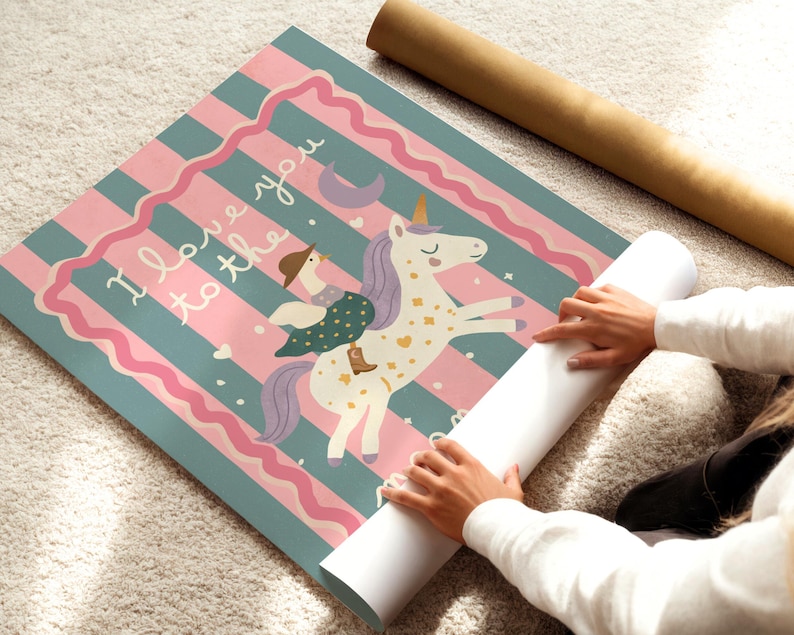 May include: A rolled-up poster featuring a whimsical illustration of a unicorn with a rider, set against a striped background of teal and pink. The text "I love you to the..." is visible. A brown cardboard tube is also present.