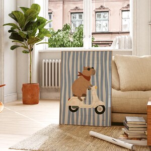 cool capybara on white scooter framed poster on wooden windowsill coastal boys bedroom decor blue stripe animal nursery print