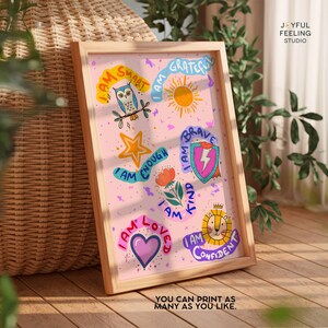 May include: A framed print with a pink background and colorful illustrations of positive affirmations. The affirmations include "I am smart", "I am grateful", "I am enough", "I am brave", "I am kind", "I am loved", and "I am confident".