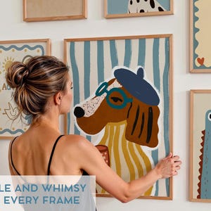May include: A collection of framed illustrations featuring whimsical animal characters. The illustrations are in a modern style with bold colors and simple lines. The frames are all wooden and have a natural finish. The illustrations include a dog wearing a beret and glasses, a crocodile with large eyes, and a bird with a sun behind it.