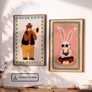 May include: Two framed art prints. One features a bear playing a trumpet, wearing sunglasses, a hat, and a vest. The other print shows a rabbit wearing star-shaped sunglasses playing a keyboard. Both prints have a decorative border and are set against a white wall.